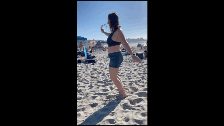 gif of a person on the beach doing a hands free knee bend to the ground