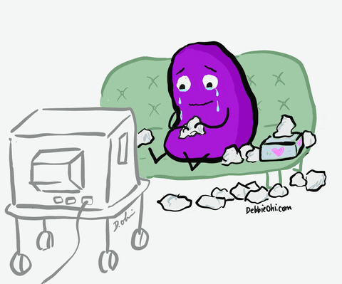 gif of a purple bean sitting on a couch watching tv and crying